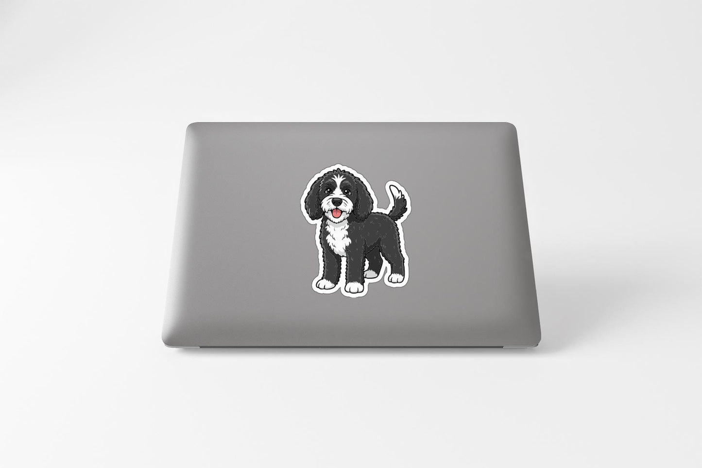 a sticker of a dog on the back of a laptop.