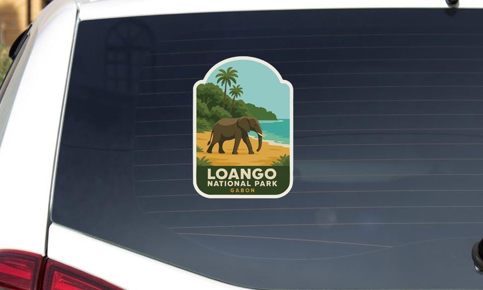 A sticker on the rear window of a car, depicting an elephant and a tropical landscape, with the text "Loango National Park" below it.