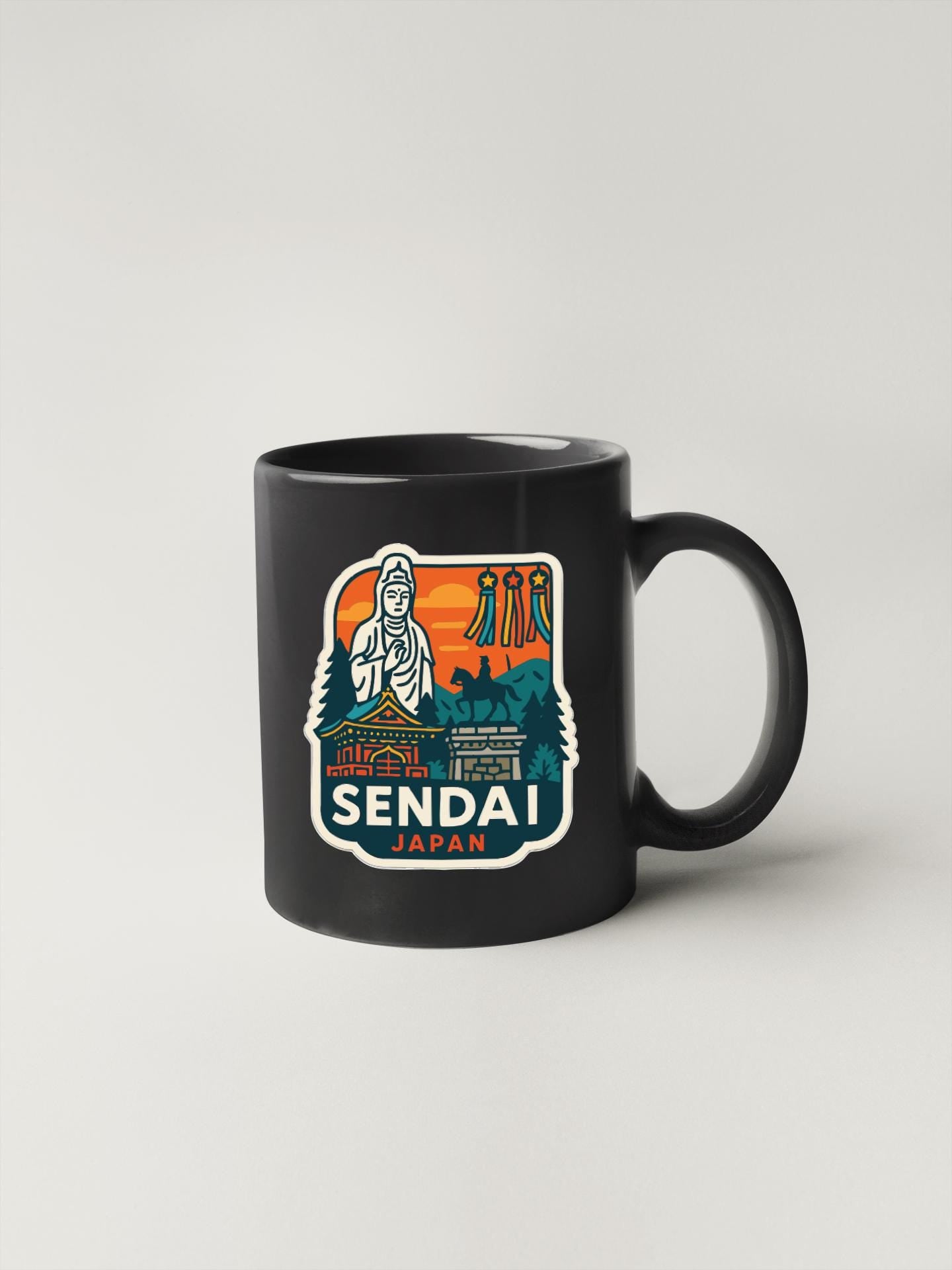 A black coffee mug with a colorful graphic design depicting a temple, mountains, and a figure, along with the text "SENDAI JAPAN".