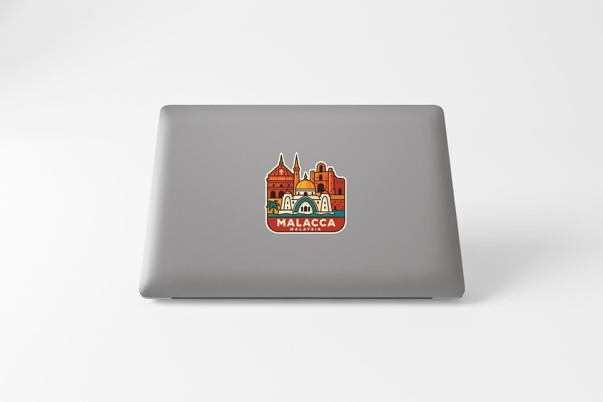 a sticker of a cityscape on the back of a laptop.