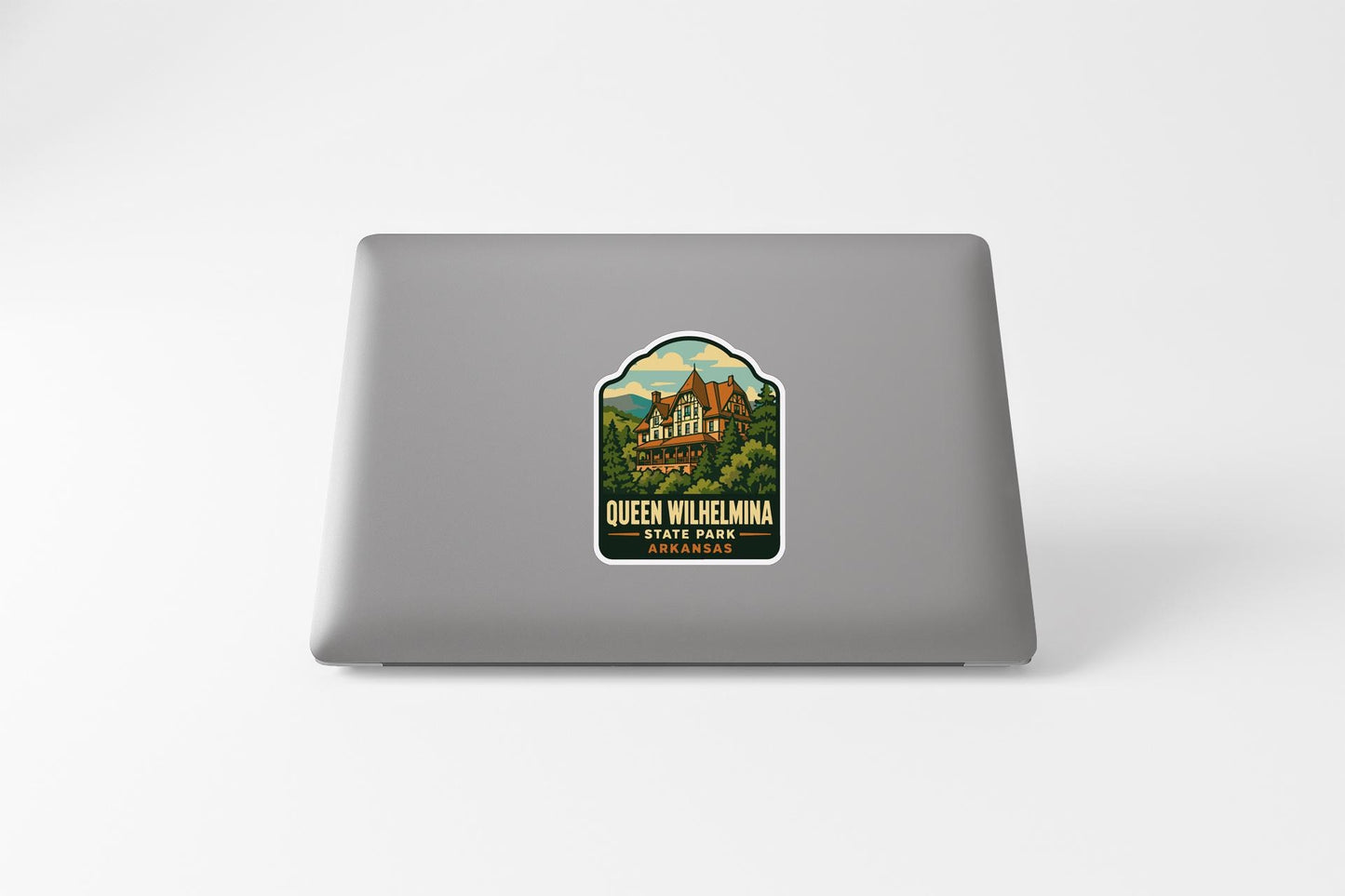 A sticker on the back of a laptop, featuring a scenic illustration of Queen Wilhelmina Park in St. Louis, Missouri.