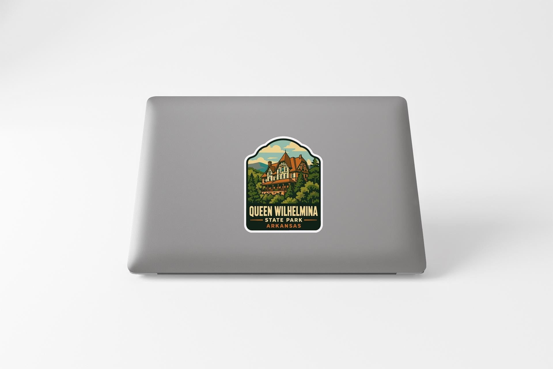 A sticker on the back of a laptop, featuring a scenic illustration of Queen Wilhelmina Park in St. Louis, Missouri.
