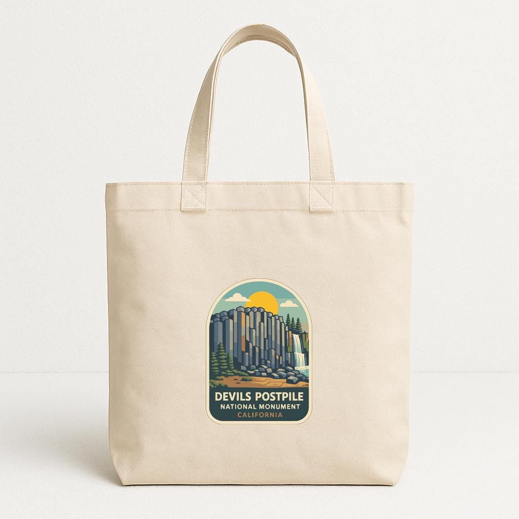 A beige tote bag with a printed design depicting the Devils Postpile National Monument in California.