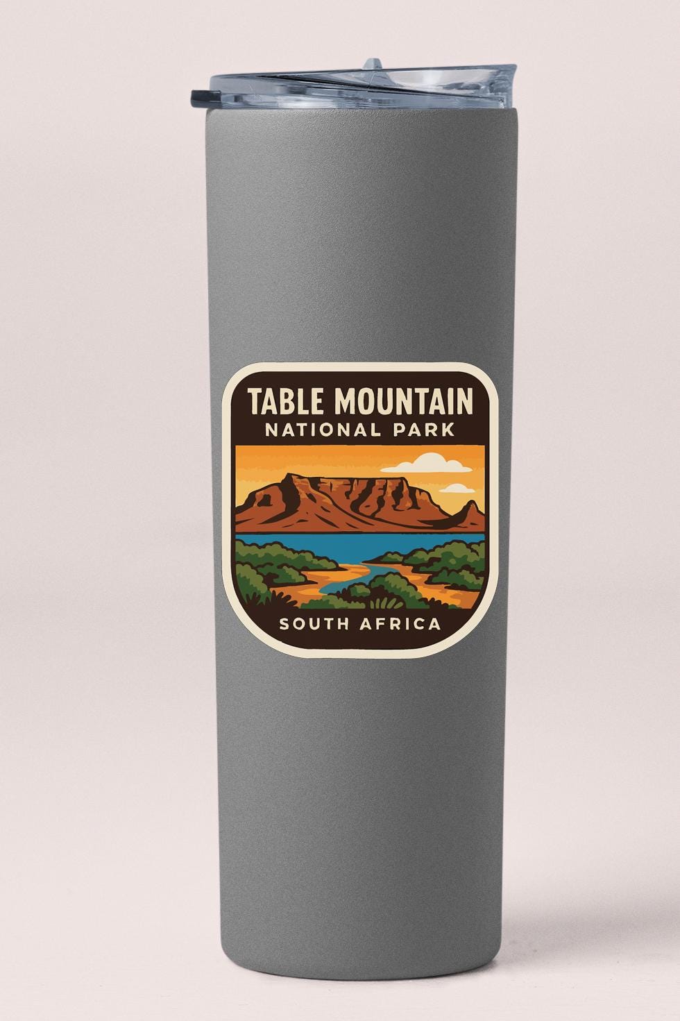 A gray insulated tumbler with a label that says "TABLE MOUNTAIN NATIONAL PARK SOUTH AFRICA".
