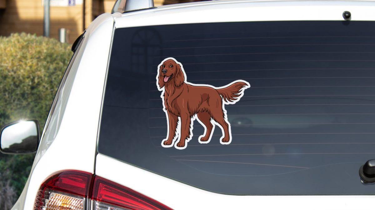 a sticker of a brown dog on the rear window of a white car.