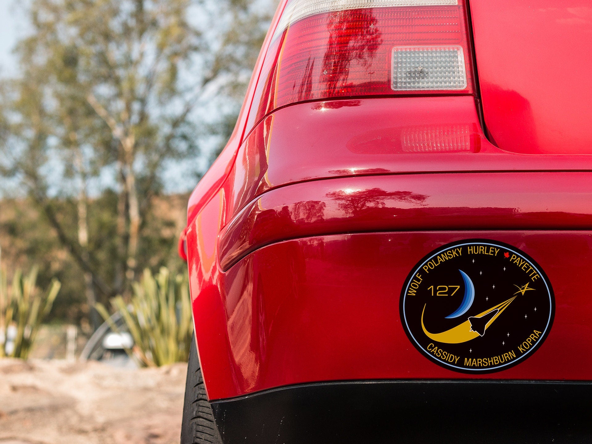 a close up of the rear end of a red car