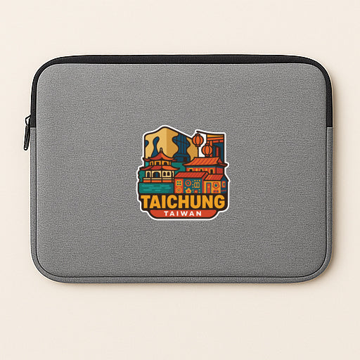 A gray laptop sleeve with a colorful sticker depicting a cityscape of Taipei, Taiwan.