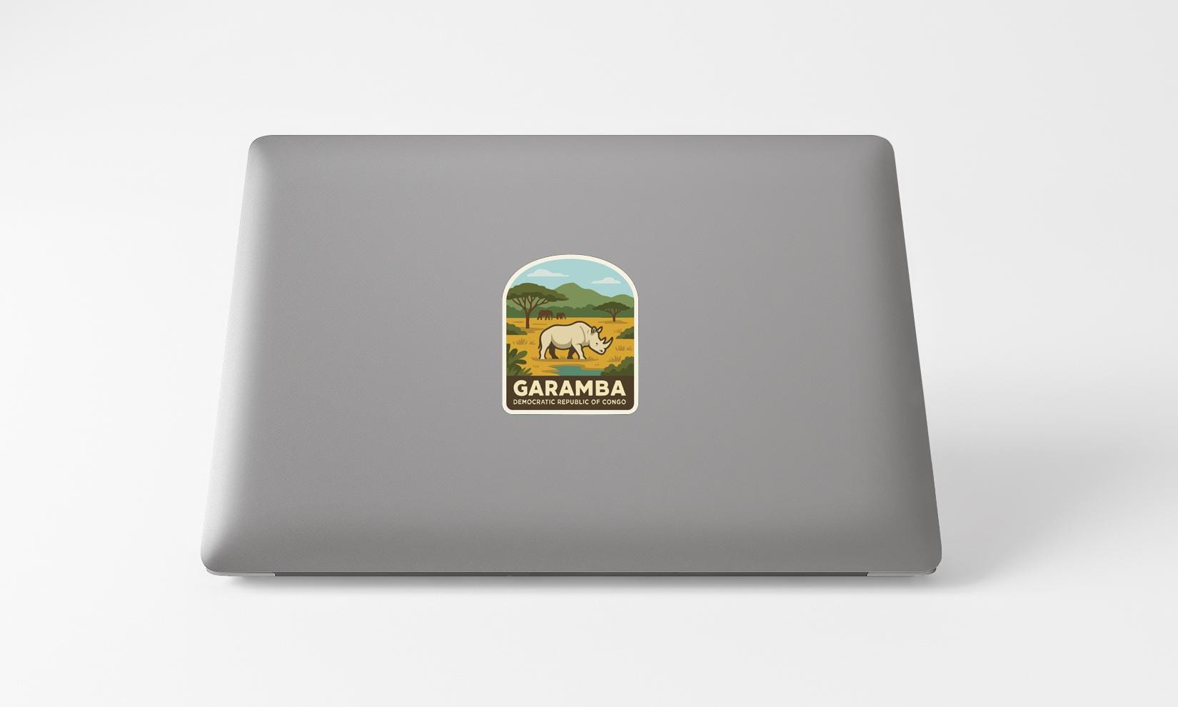 a sticker with a graphic of a rhinoceros and the text "GARAMBA" on a laptop.