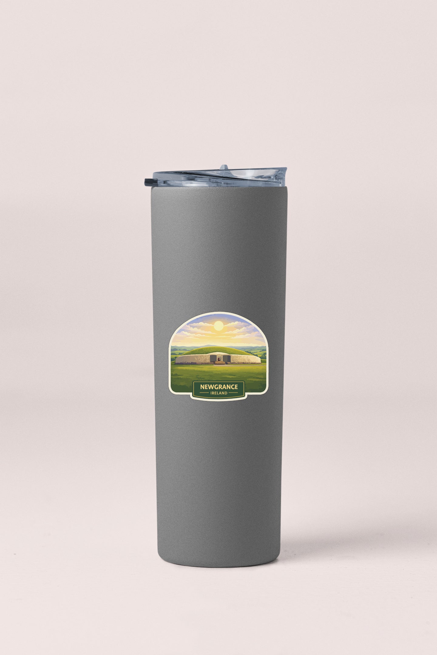 A gray insulated tumbler with a label that says "Newgrange, Ireland".