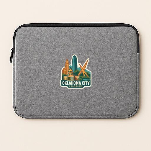 a gray laptop sleeve with a sticker of the Oklahoma City skyline.
