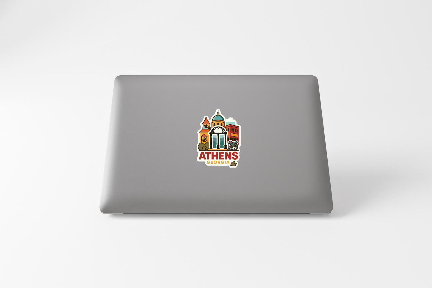 a sticker with a cityscape and the text "ATHENS GEORGIA" on the back of a laptop.