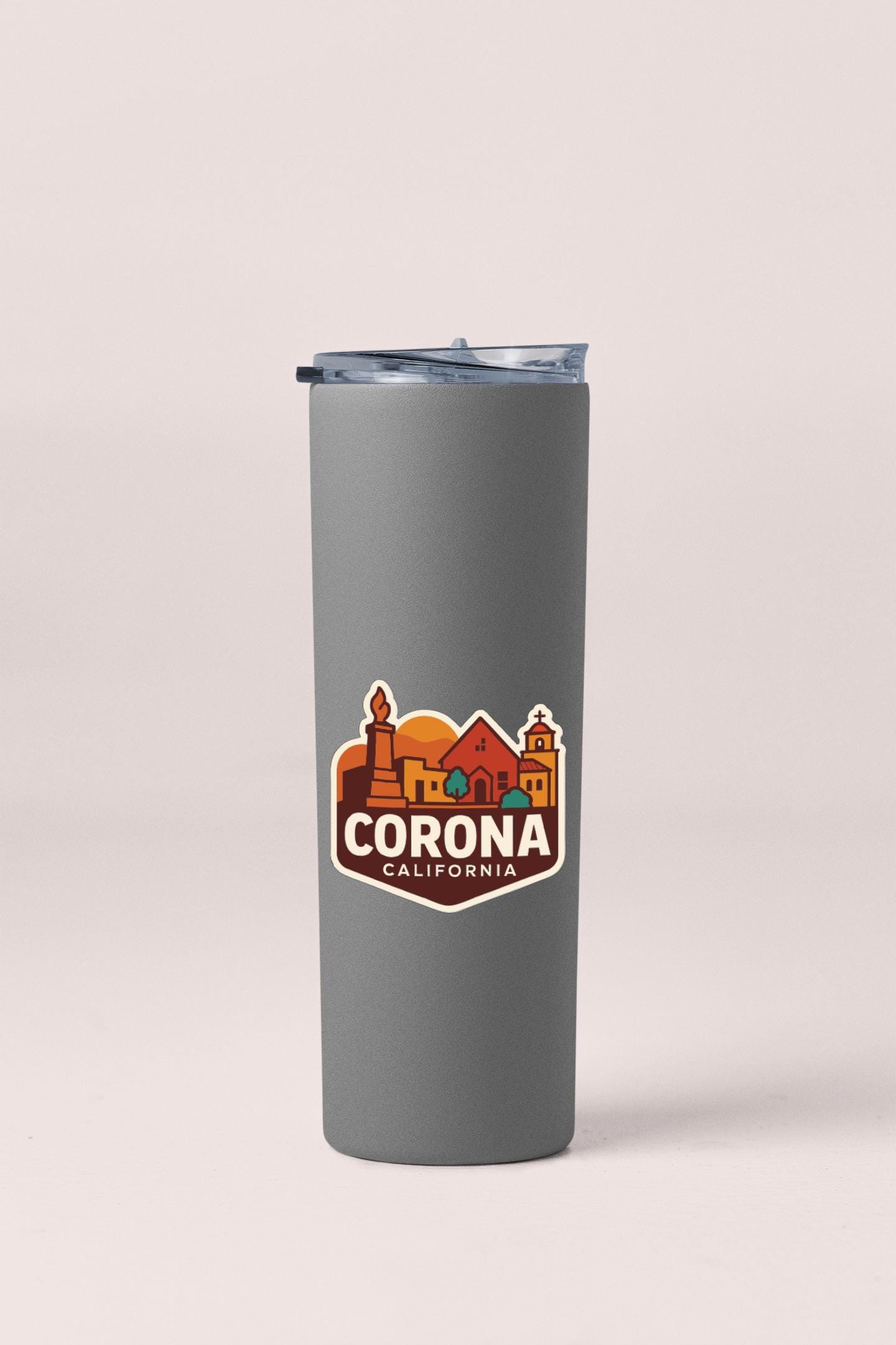 A gray insulated tumbler with a printed logo that says "CORONA CALIFORNIA".