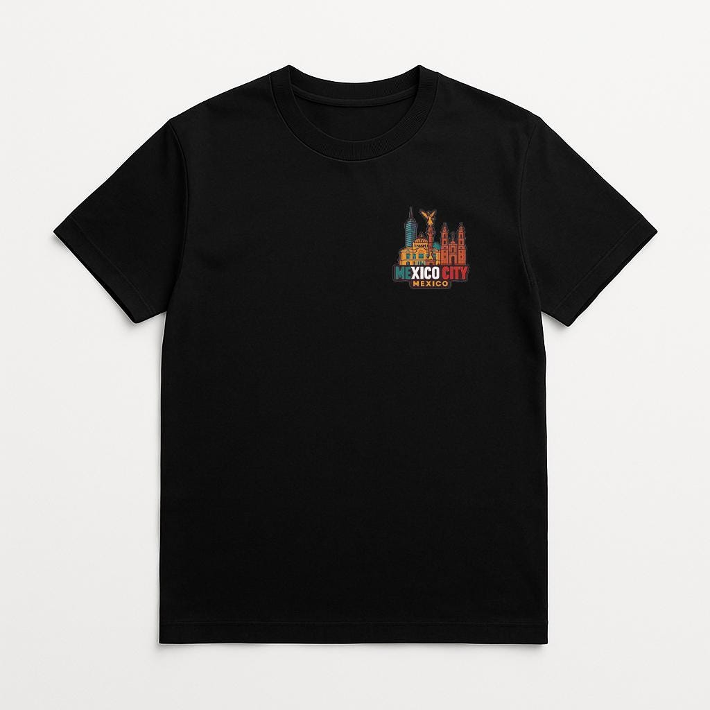 A black t-shirt with a graphic design depicting a city skyline and the text "MEXICO CITY" printed on it.