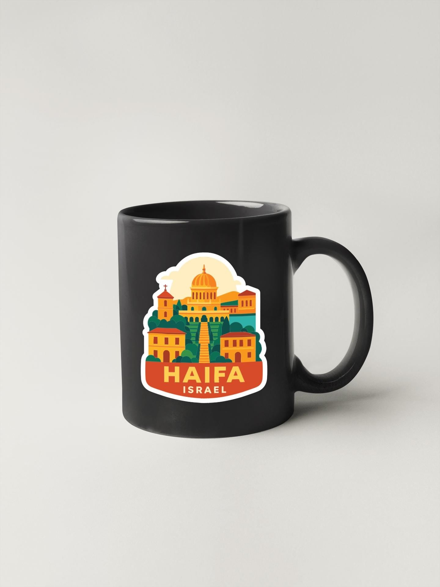 A black coffee mug with a colorful sticker depicting the Haifa, Israel cityscape.