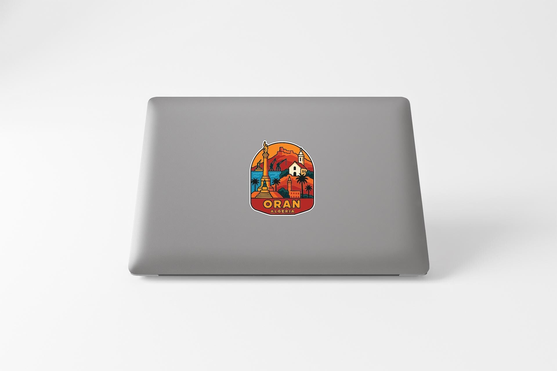 a sticker on the back of a laptop with an illustration of a person and a mountain.