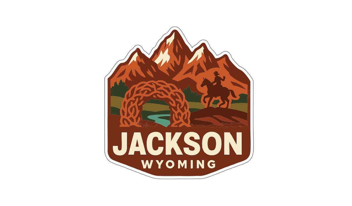 A stylized logo featuring mountains, a cowboy on horseback, and a river, with the text "JACKSON WYOMING" prominently displayed.