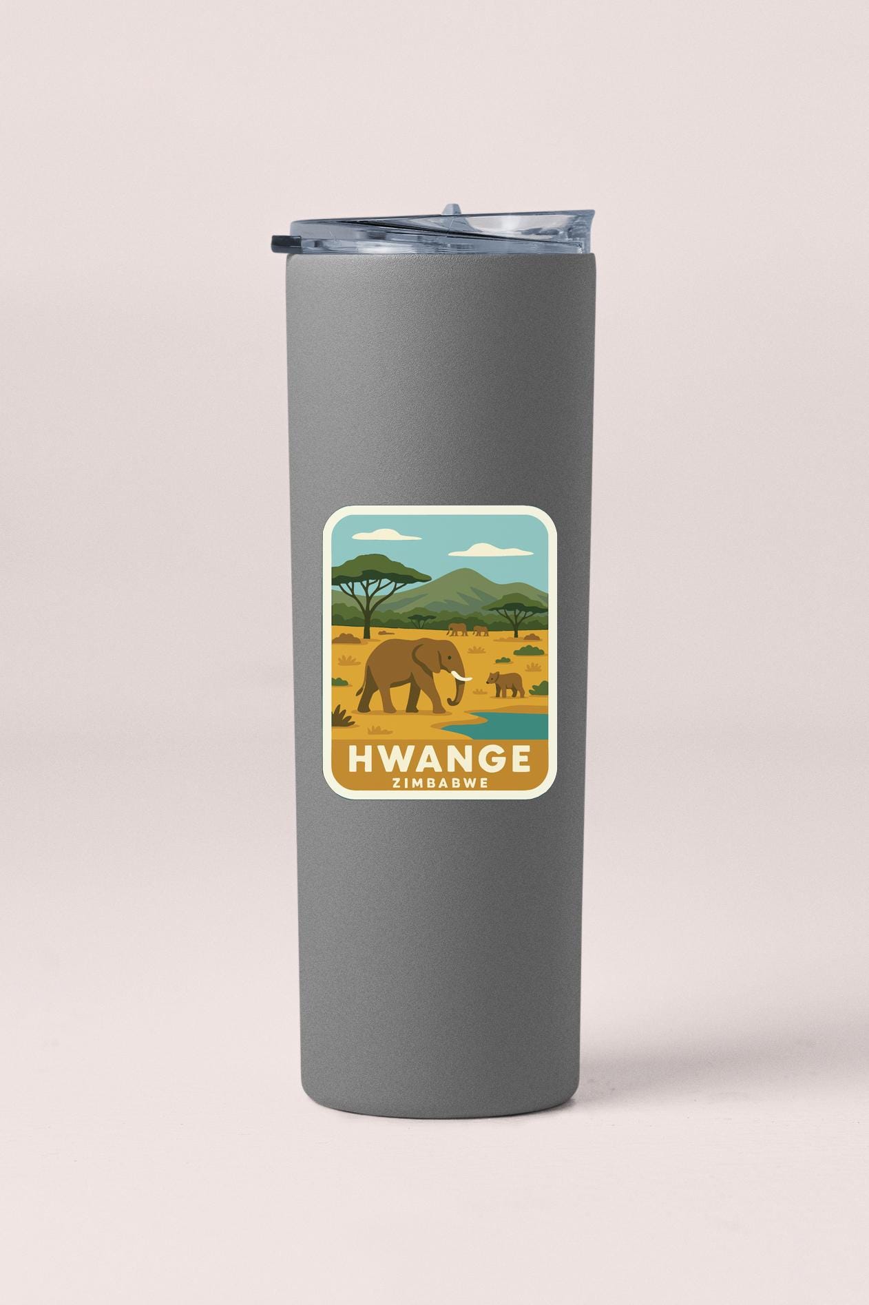 A gray tumbler with a sticker depicting an elephant and the text "HWANGE ZIMBABWE" printed on it.