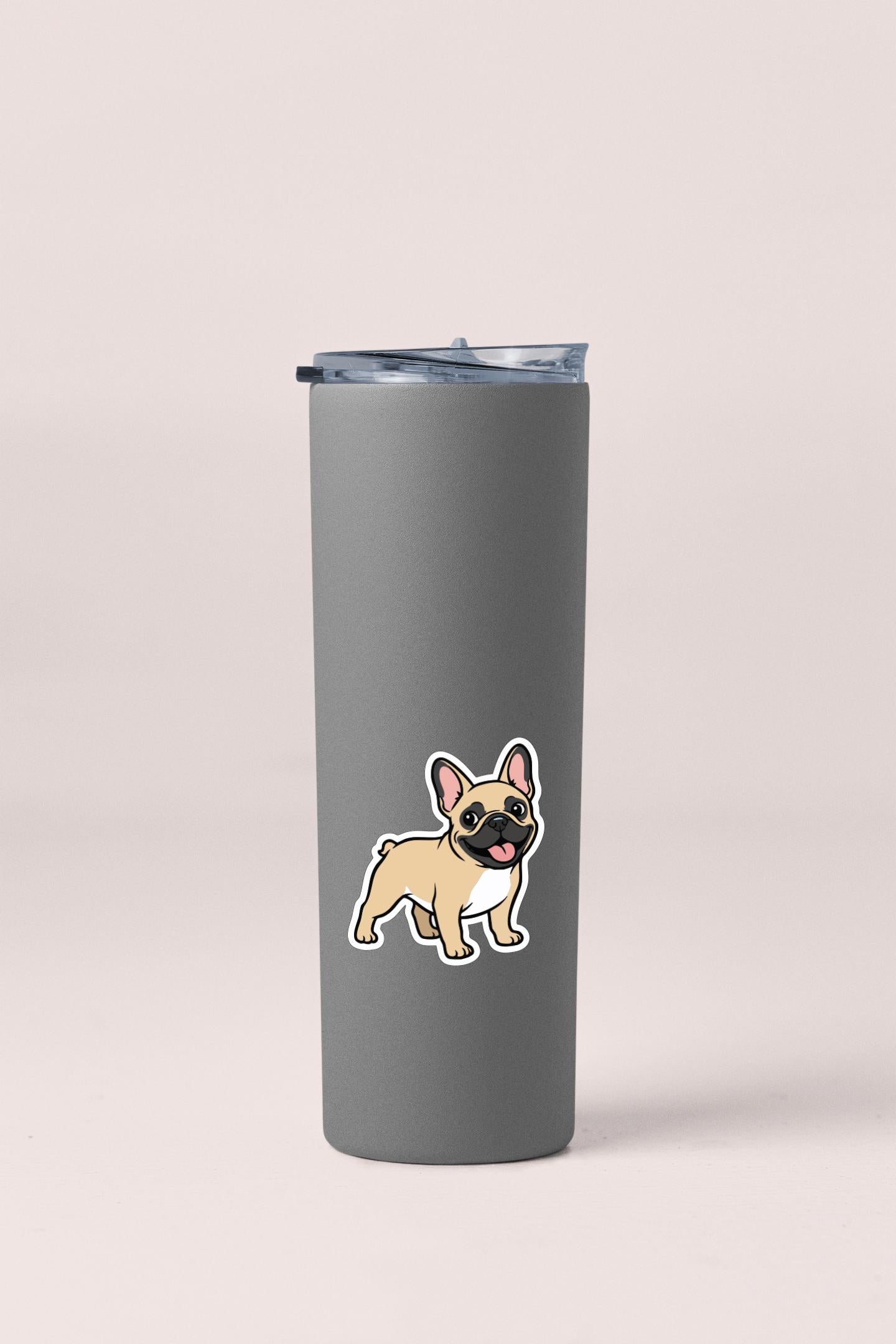 A gray insulated tumbler with a sticker of a cartoon dog on it.