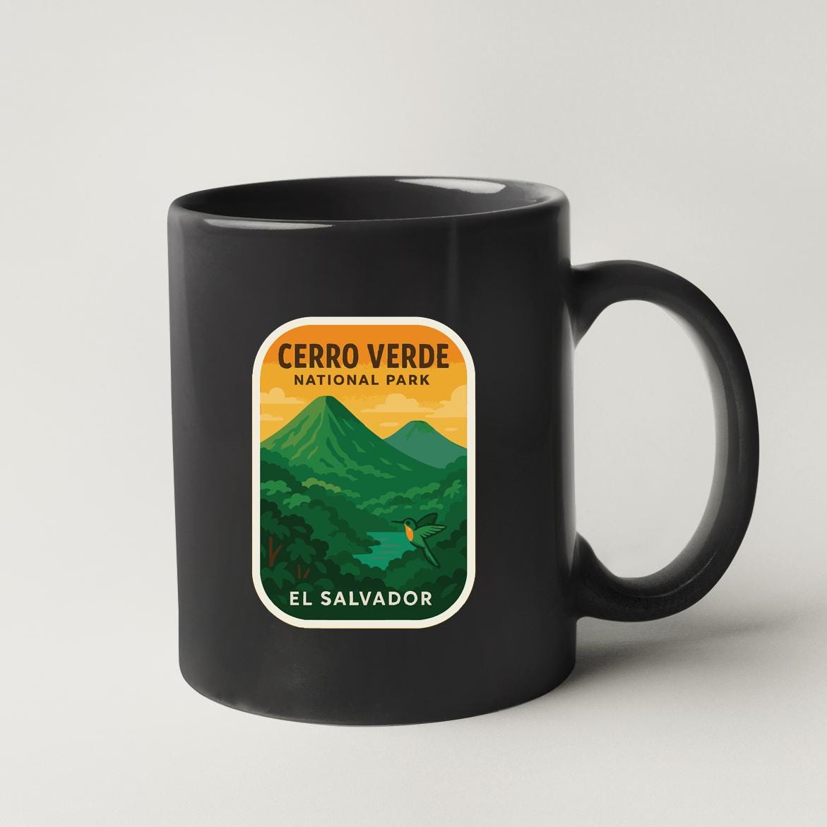 A black coffee mug with a label that says "CERRO VERDE NATIONAL PARK EL SALVADOR".