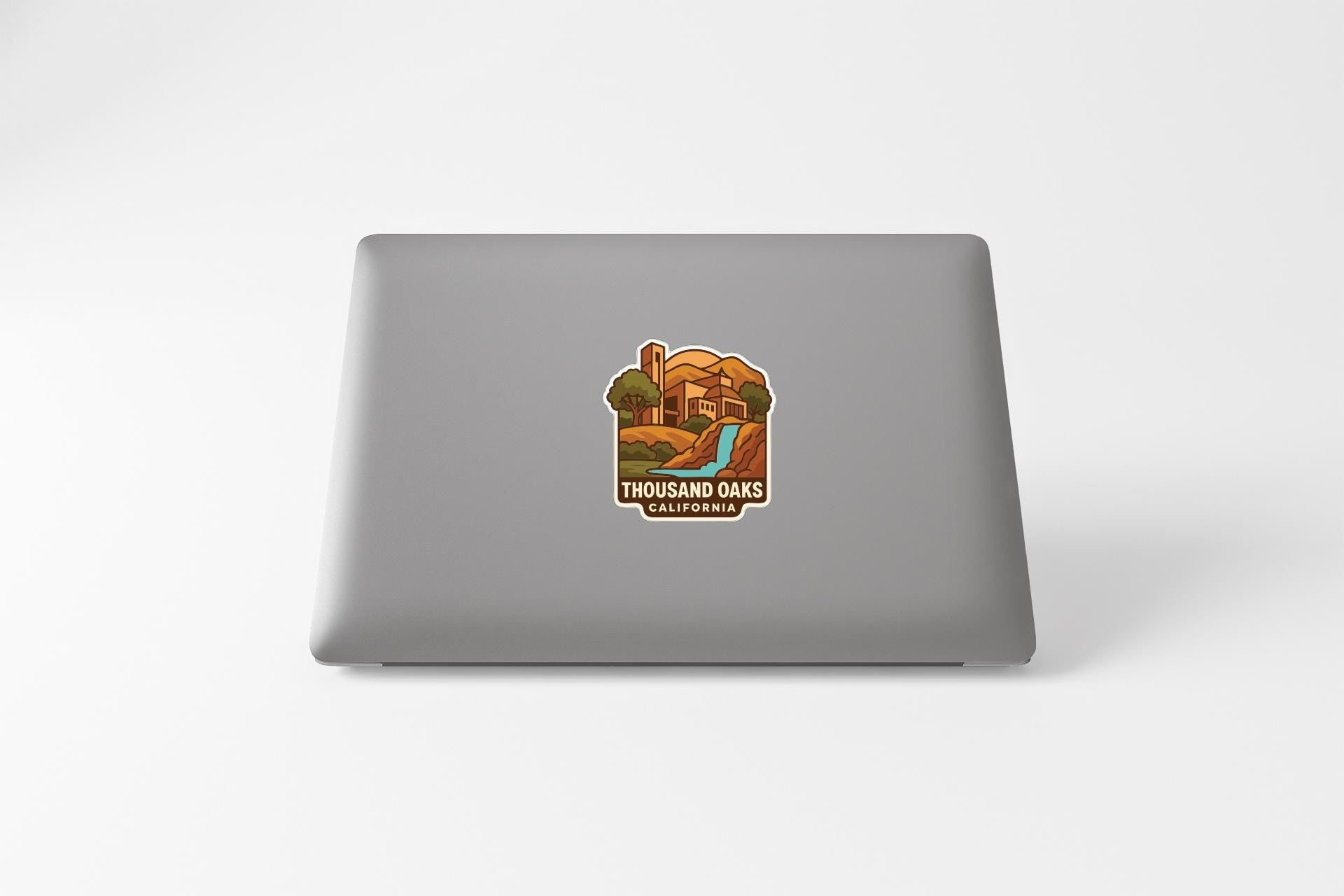 a sticker on the back of a laptop that says "THOUSAND OAKS CALIFORNIA".