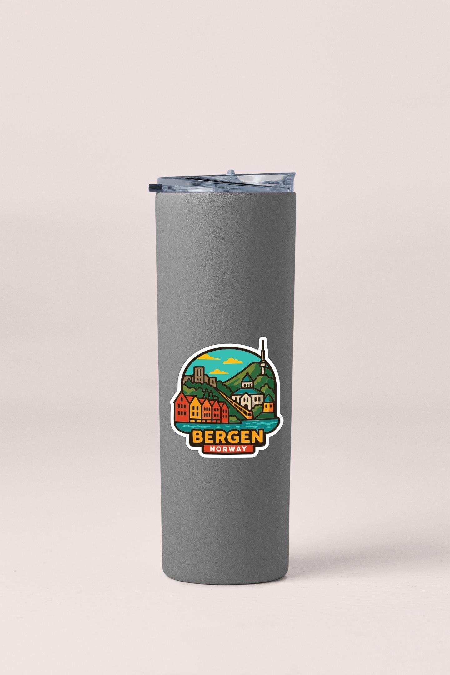 A gray insulated tumbler with a sticker depicting a colorful illustration of a cityscape and the text "BERGEN, NORWAY" printed on it.