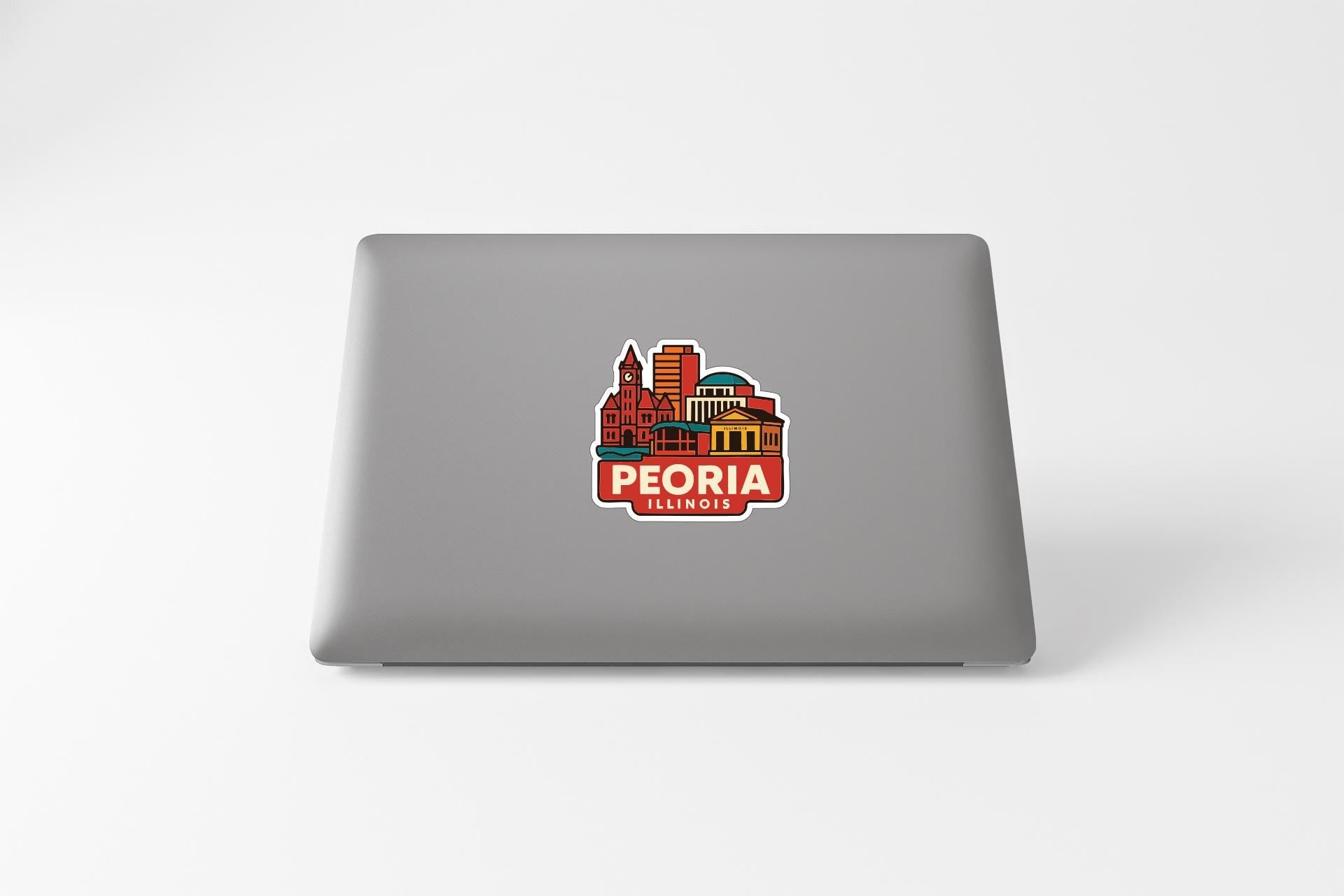 a sticker of the city of Peoria, Illinois, on the back of a laptop.
