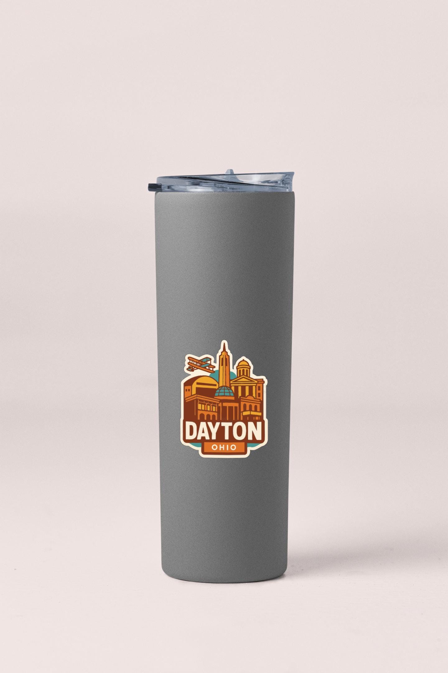 A gray insulated tumbler with a graphic design depicting the city of Dayton, Ohio.