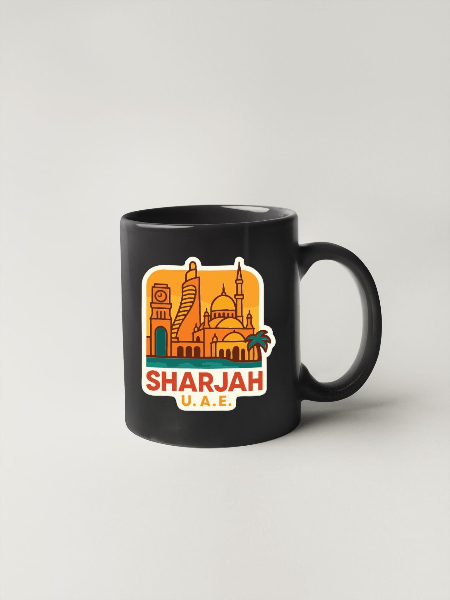 A black coffee mug with a sticker depicting the skyline of Sharjah, United Arab Emirates.