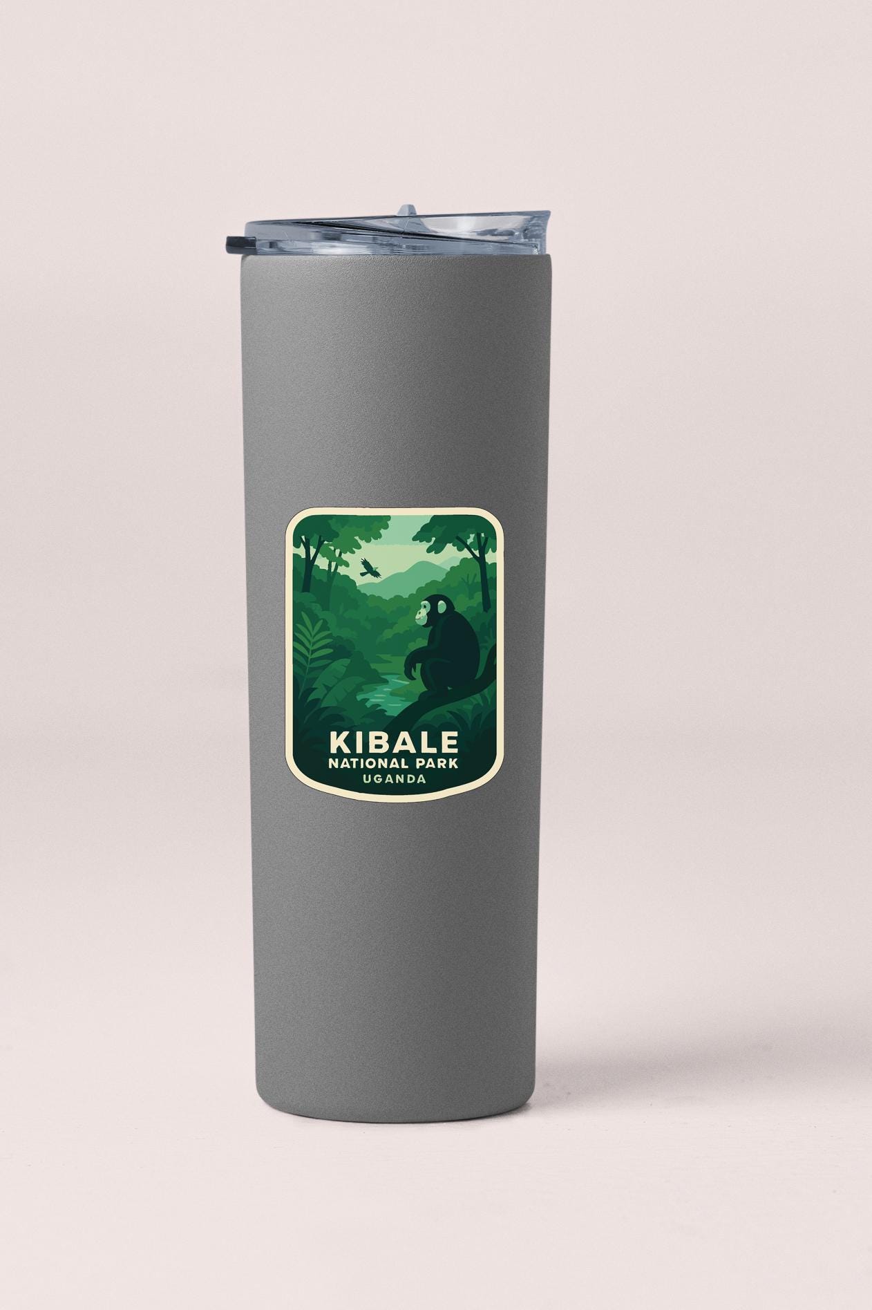 A gray cylindrical container with a label that reads "Kibale National Park Uganda" and features a green illustration of a forest scene with a bear.