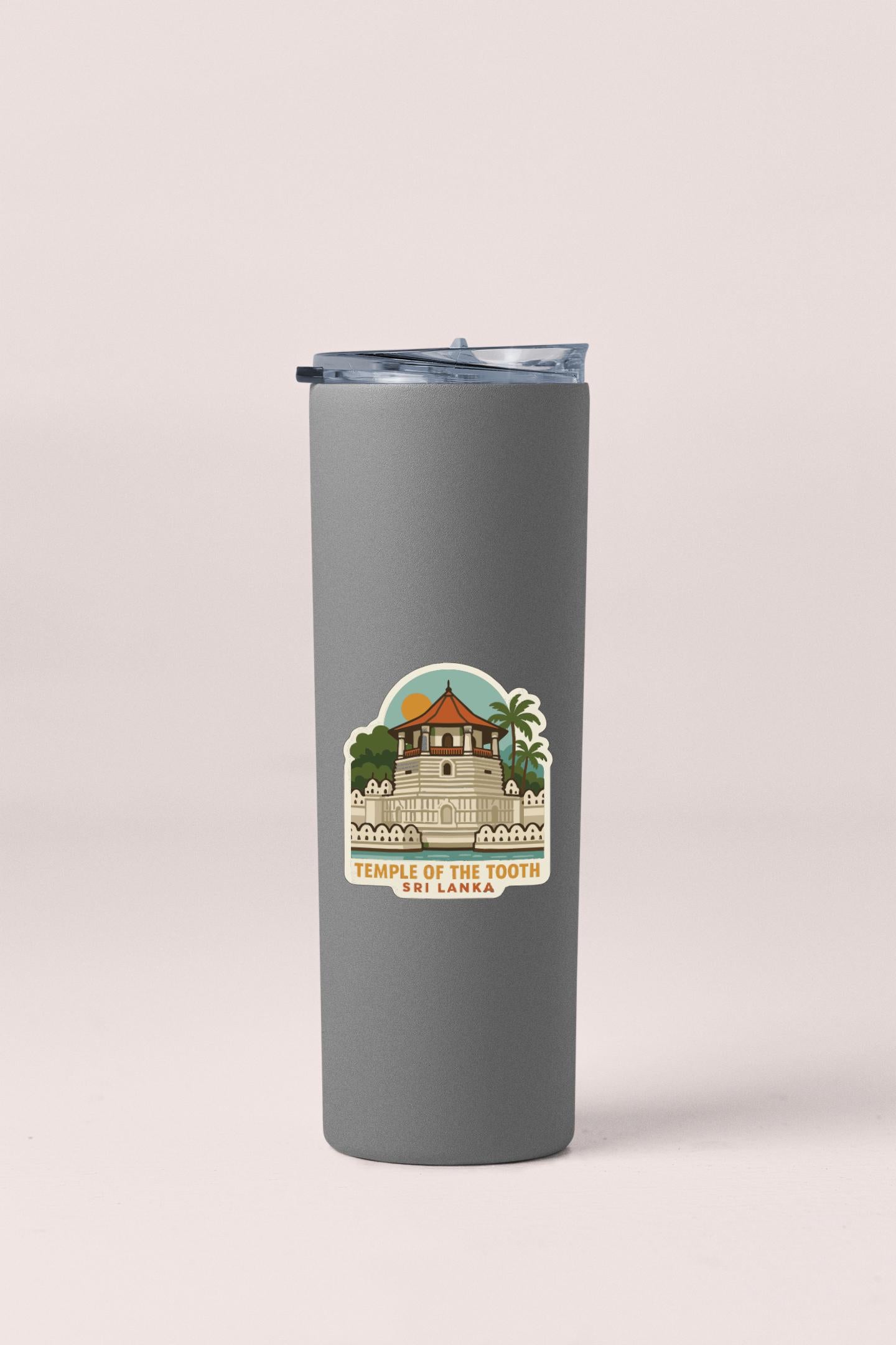 A gray insulated tumbler with a sticker depicting the Temple of the Tooth in Sri Lanka.