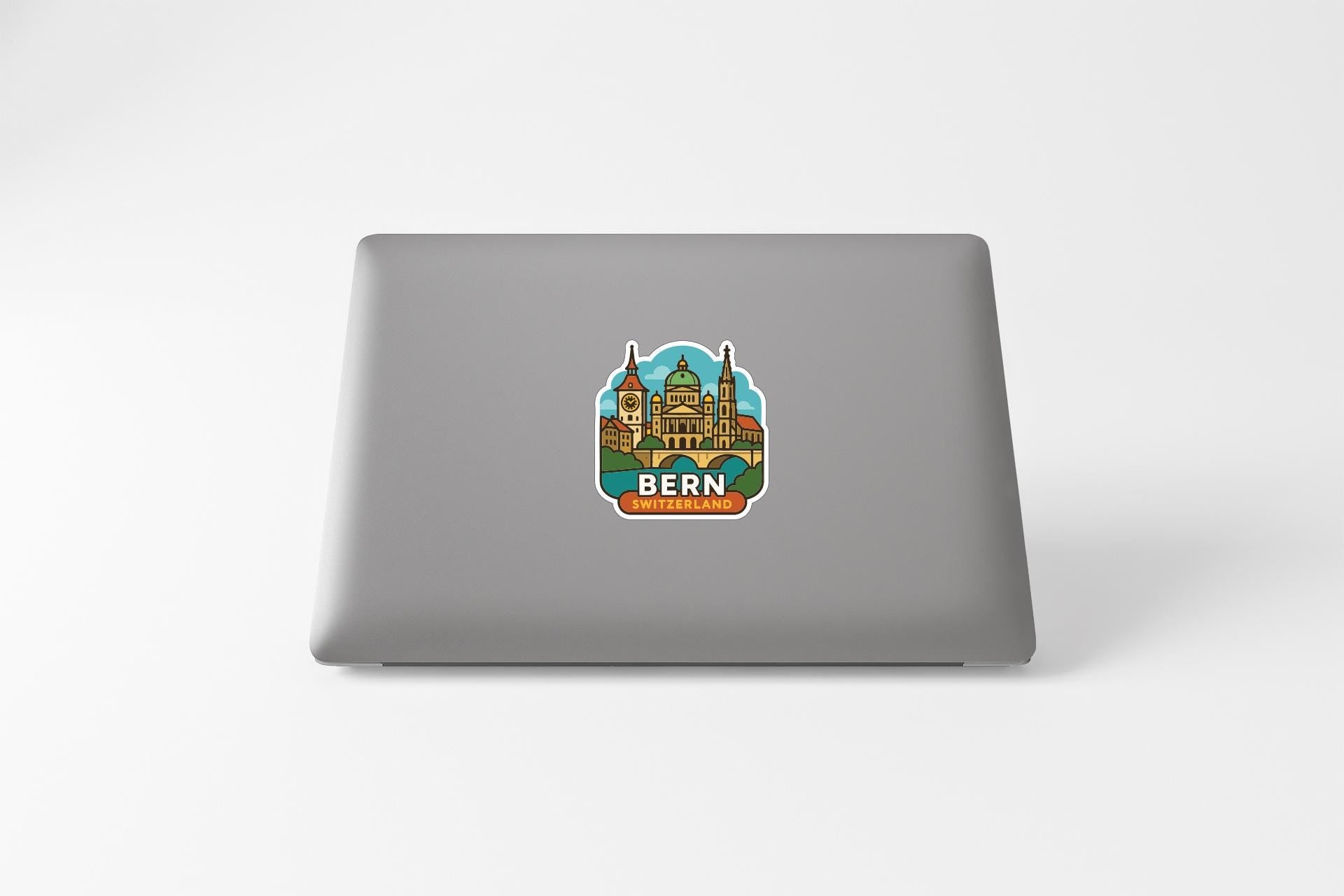 A sticker depicting the Bern, Switzerland skyline on the back of a laptop computer.