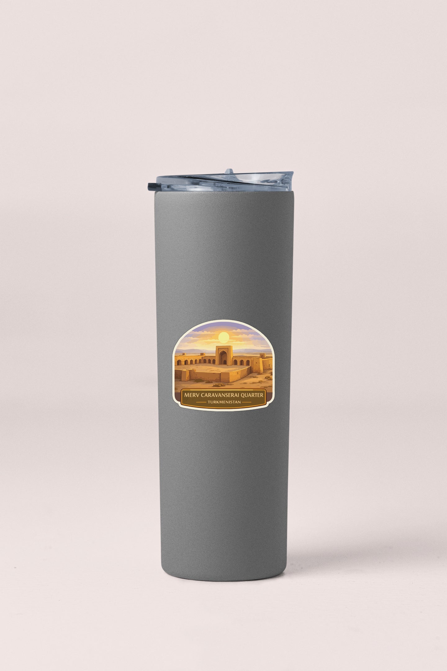 A gray cylindrical container with a lid and a label featuring a sunset image.