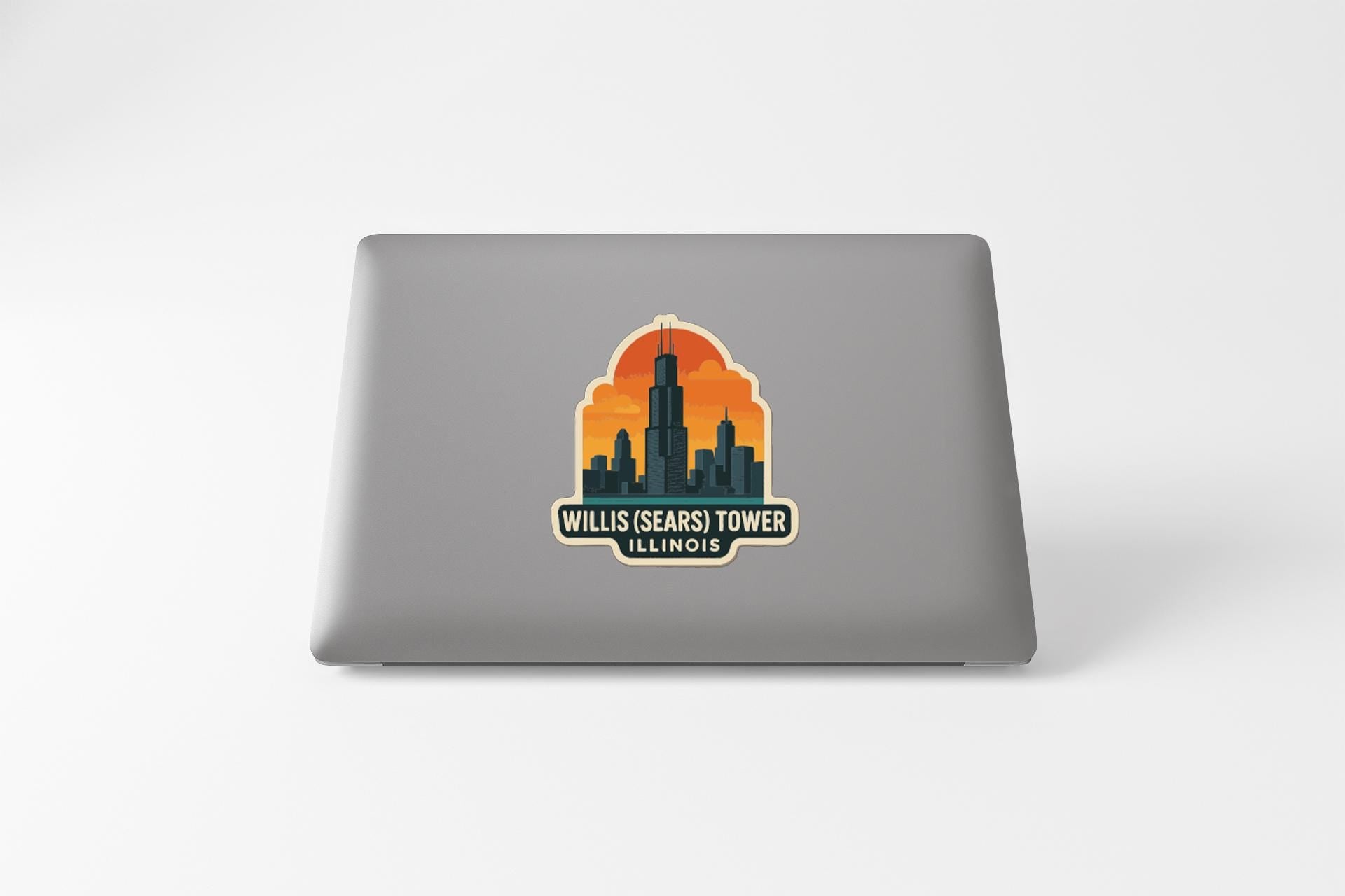 A sticker on the back of a laptop that features an illustration of the Willis Tower, also known as the Willis Tower, in Chicago, Illinois.