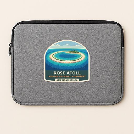 a gray laptop sleeve with a sticker depicting a tropical island and ocean.