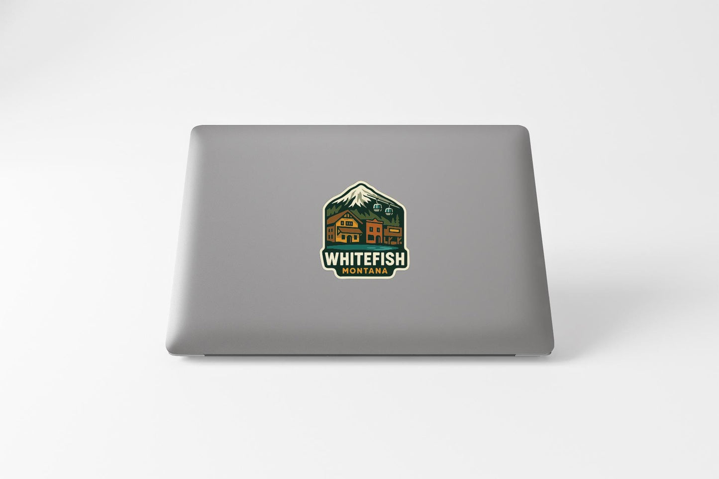 A sticker on the back of a laptop that says "WHITEFISH MONTANA".