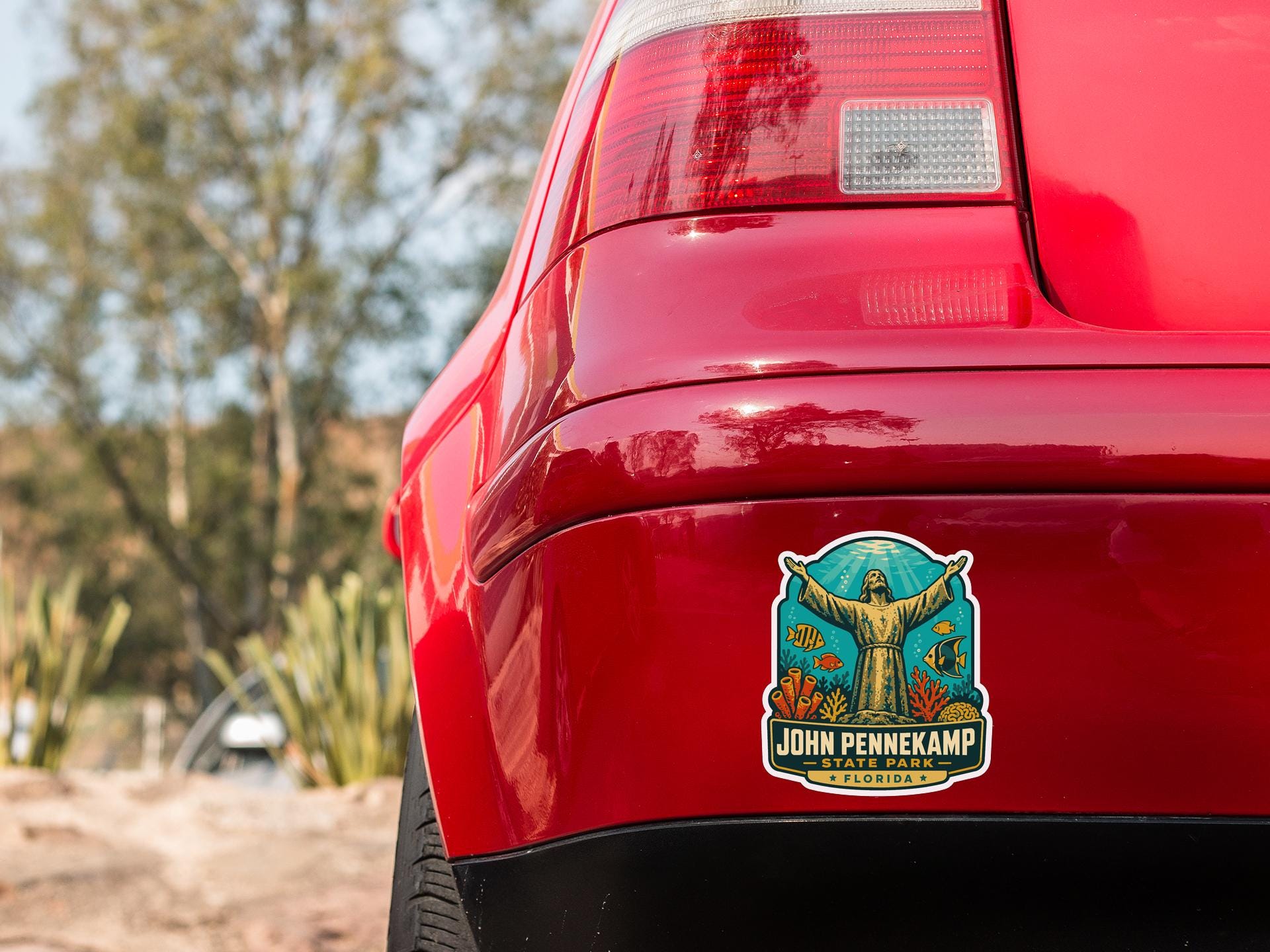 the rear end of a red car with a sticker on the bumper that says "JOHN PENKAMP FLORIDA".