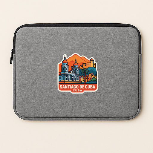 A gray laptop sleeve with a colorful sticker depicting the skyline of Santiago de Cuba.