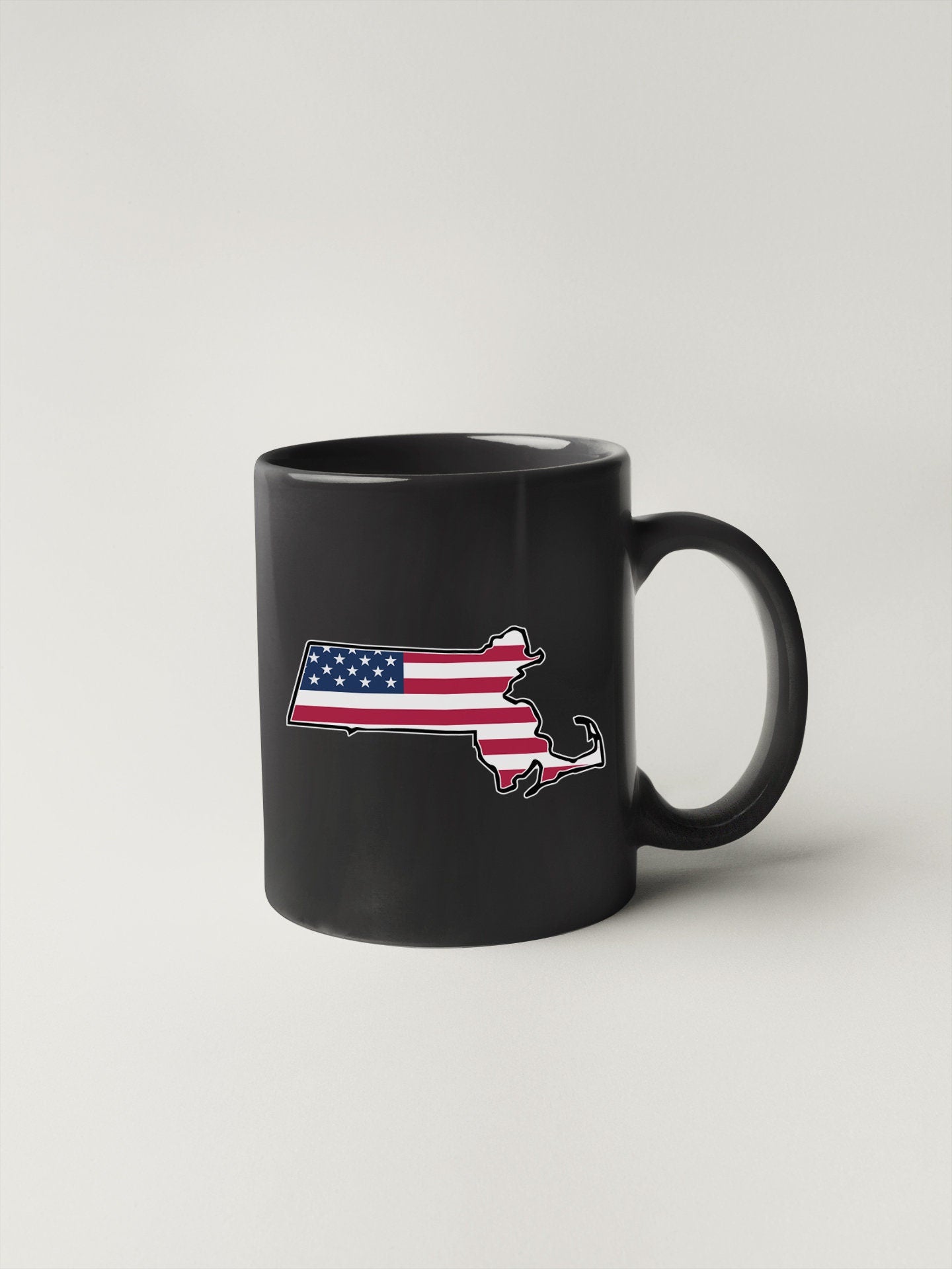 a black coffee mug with an american flag on it