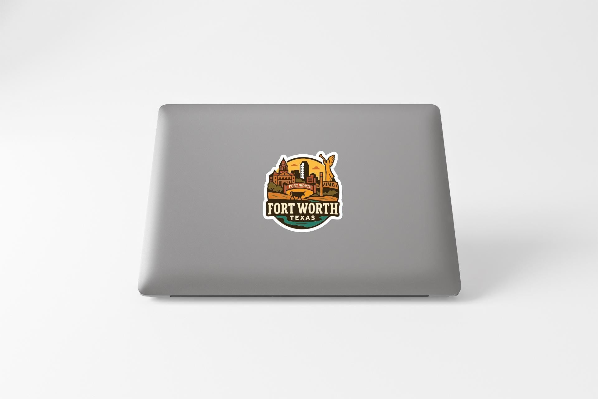 a sticker with a graphic of Fort Worth, Texas, on the back of a laptop.