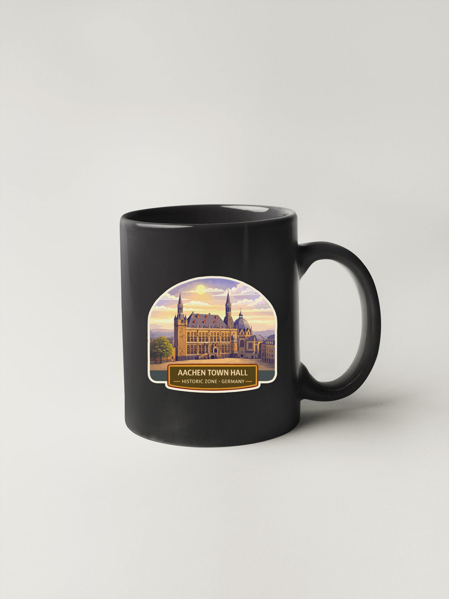 A black coffee mug with a label that says "AACIEN TOWN HALL - HISTORIC ZONE - GERMANY".