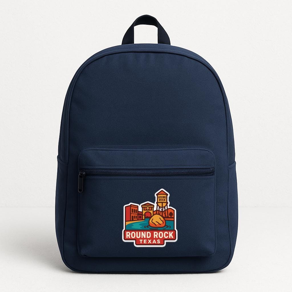 A navy blue backpack with a round rock logo on the front pocket.