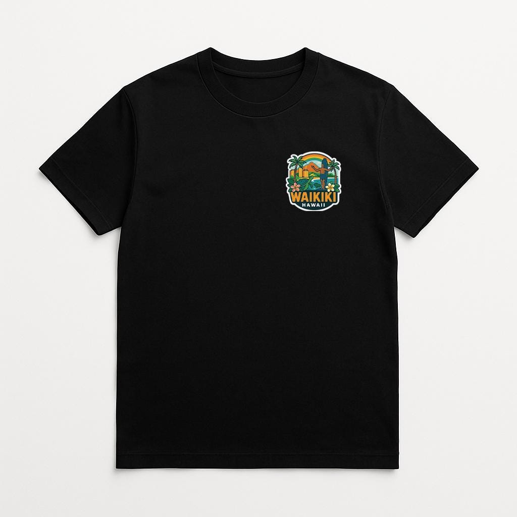 A black t-shirt with a graphic design on the front, featuring a palm tree and the text "WAIKI" in a stylized font.