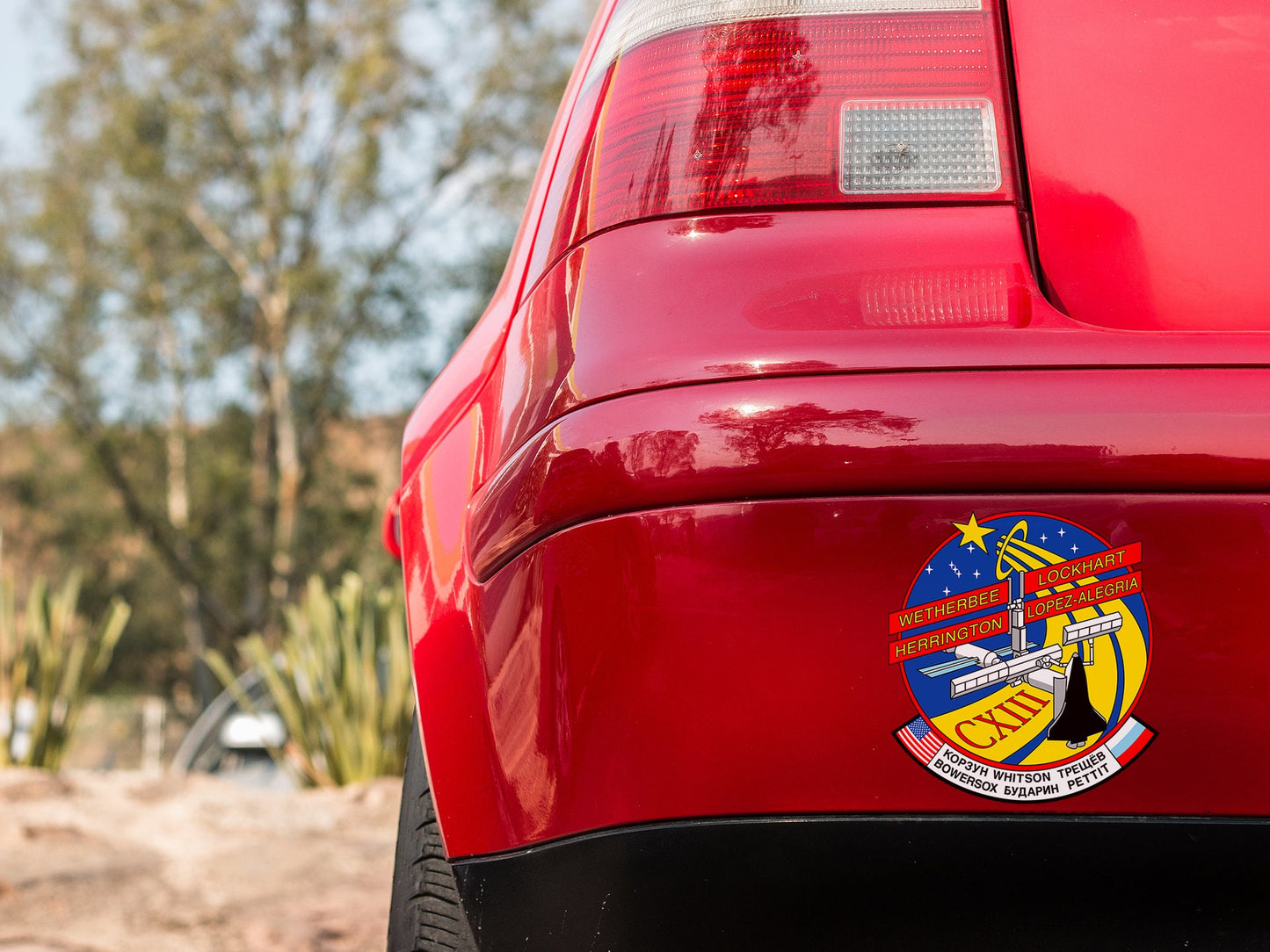 a close up of a red car with a badge on it