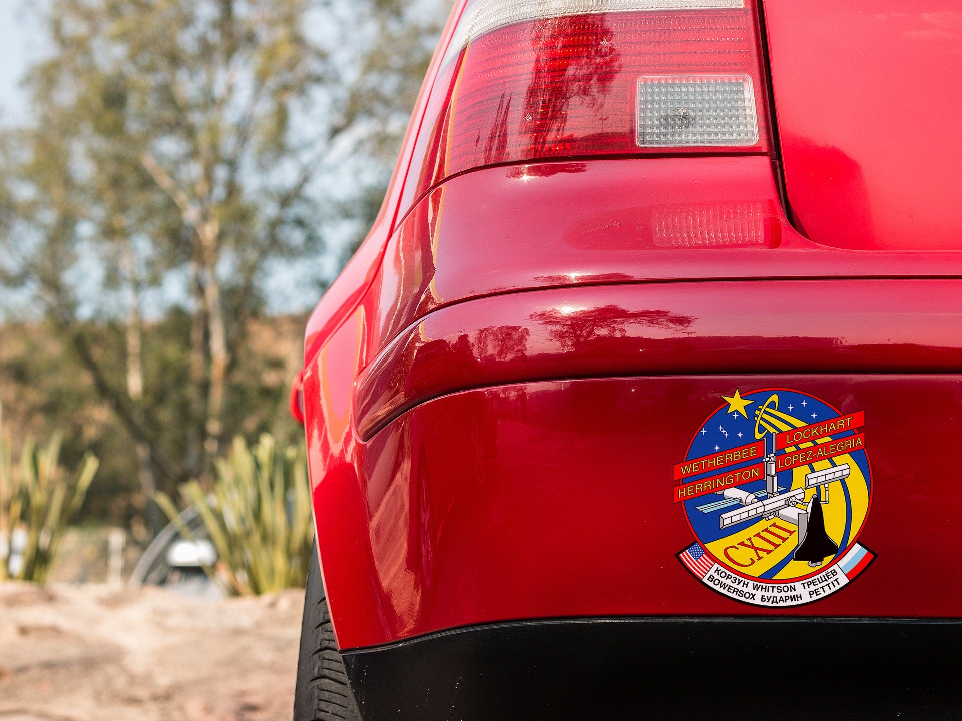 a close up of a red car with a badge on it