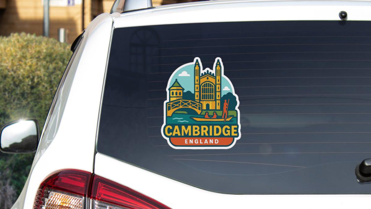 A sticker on the rear window of a car that features a colorful illustration of a landmark, along with the text "CAMBRIDGE ENGLAND".
