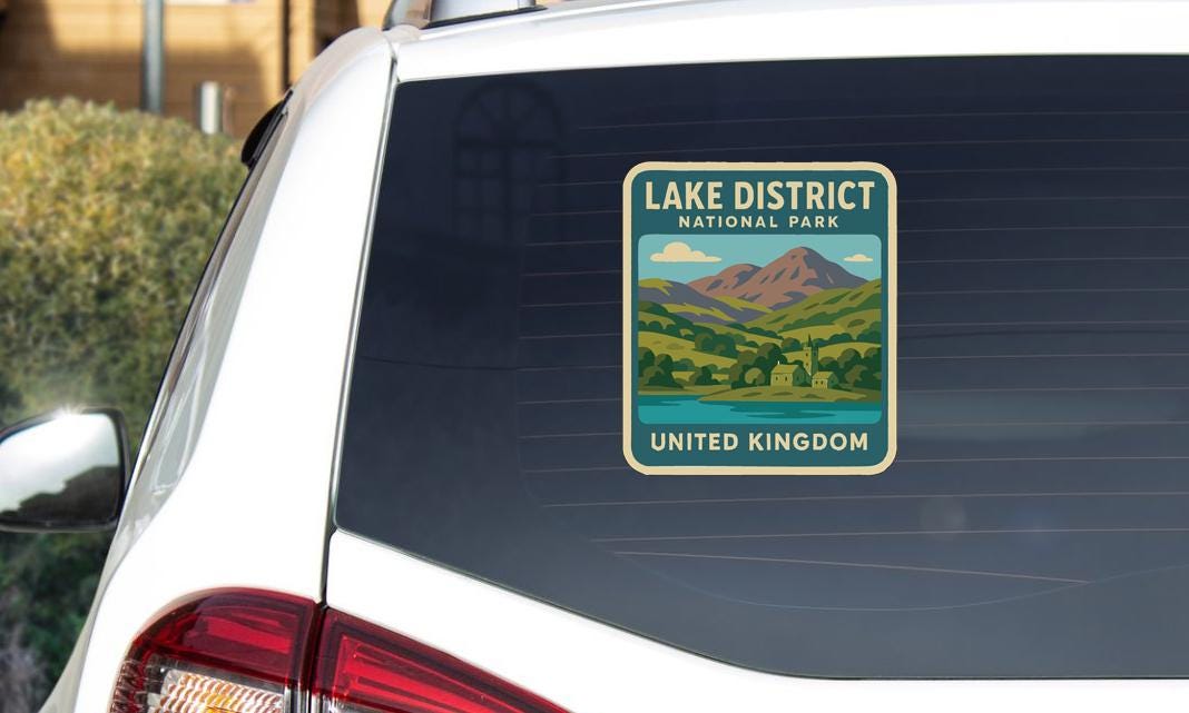 A sticker on the rear window of a car that says "Lake District National Park" and "United Kingdom".