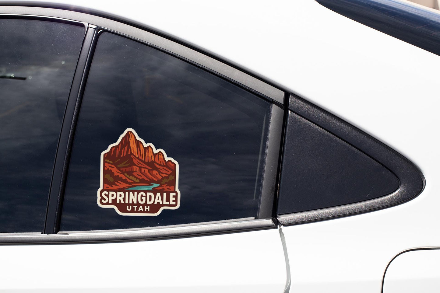 A sticker on the side of a car window, depicting a mountain landscape with the text "SPRINGdale Utah".