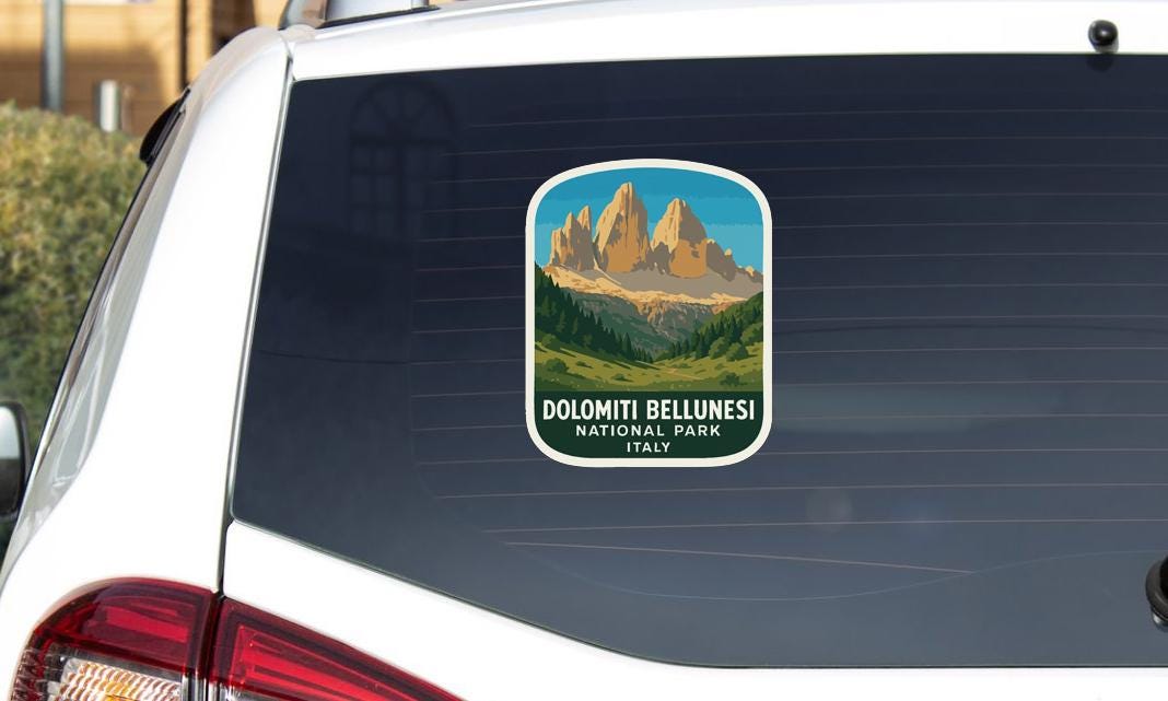 A sticker on the rear window of a car that says "DOLOMITI BELLUNESI NATIONAL PARK ITALY".