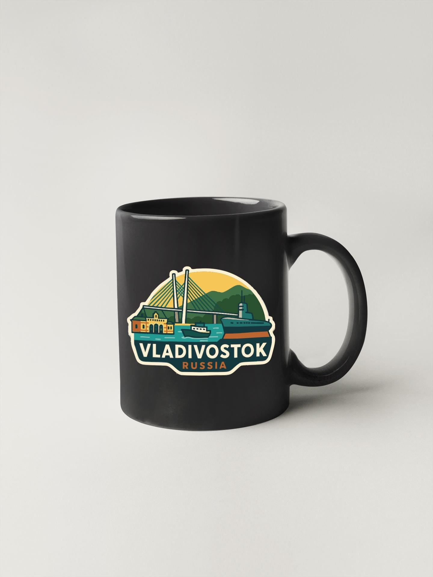 A black coffee mug with a graphic design depicting a bridge and mountains, along with the text "VLADIVOSTOK RUSSIA".
