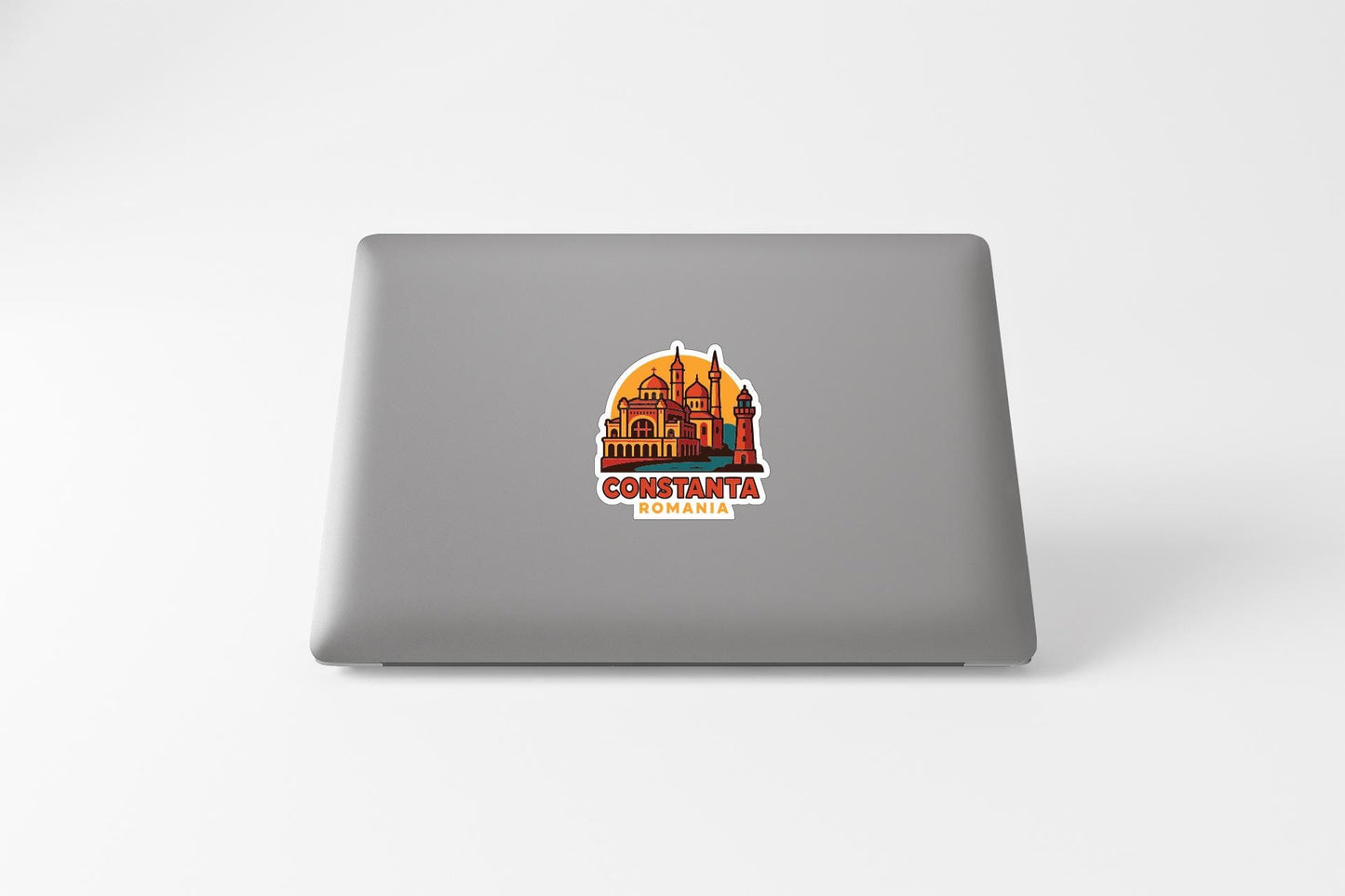 a sticker with a graphic of a building and the text "CONSTANTA ROMANIA" on a grey laptop.